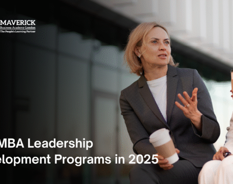Two professional women discussing leadership over coffee outside an office building, promoting Top MBA Leadership Development Programs in 2025 by Maverick Business Academy London
