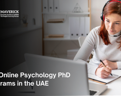 Female student attending an online psychology PhD class in the UAE, taking notes during a virtual lecture on her laptop wearing headphones.