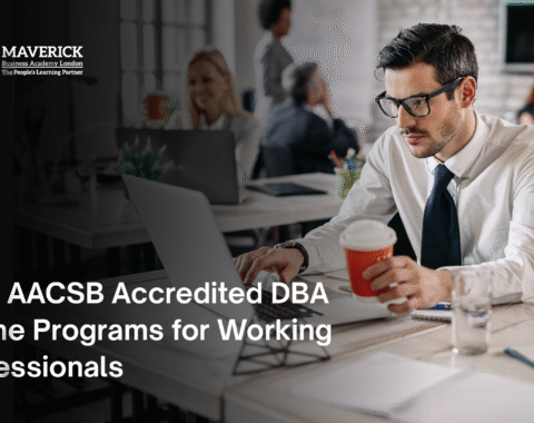 Business professional working on a laptop with coffee in hand, representing AACSB accredited online DBA programs for working professionals.