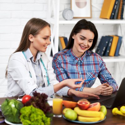 smiling-nutritionist-advises-young-patient-woman-proper-nutrition-dieting